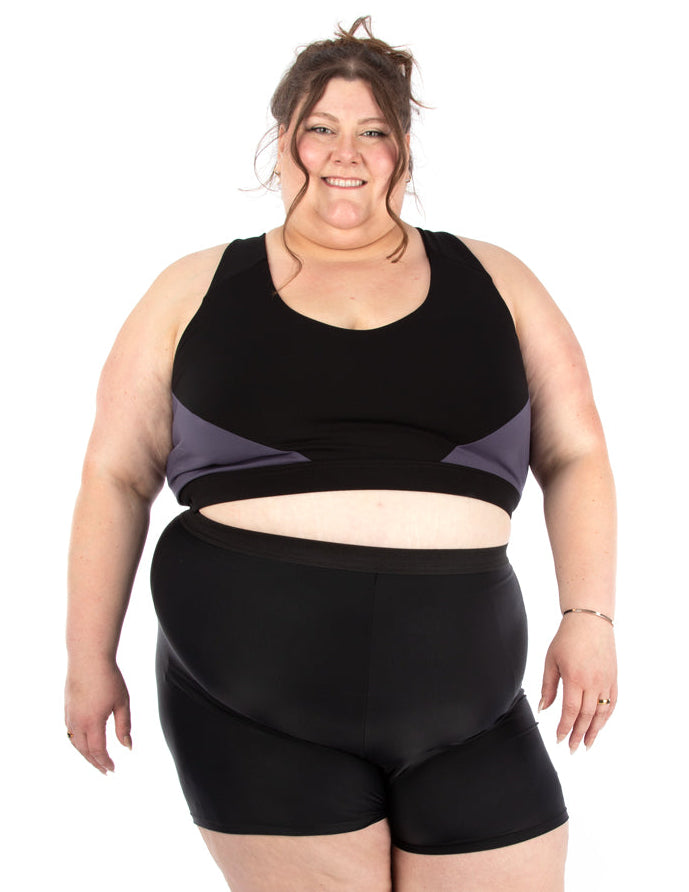 Woman wearing a two-tone Jalie 4014 COCO sports bra and 4273 JUSTINE shorts, set on a white background