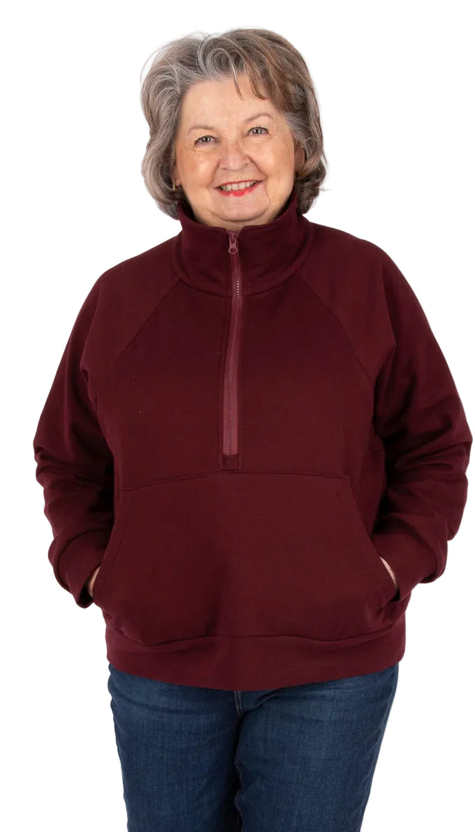 Woman wearing a maroon cropped Sophie half-zip sweatshirt made with sewing pattern Jalie 4674